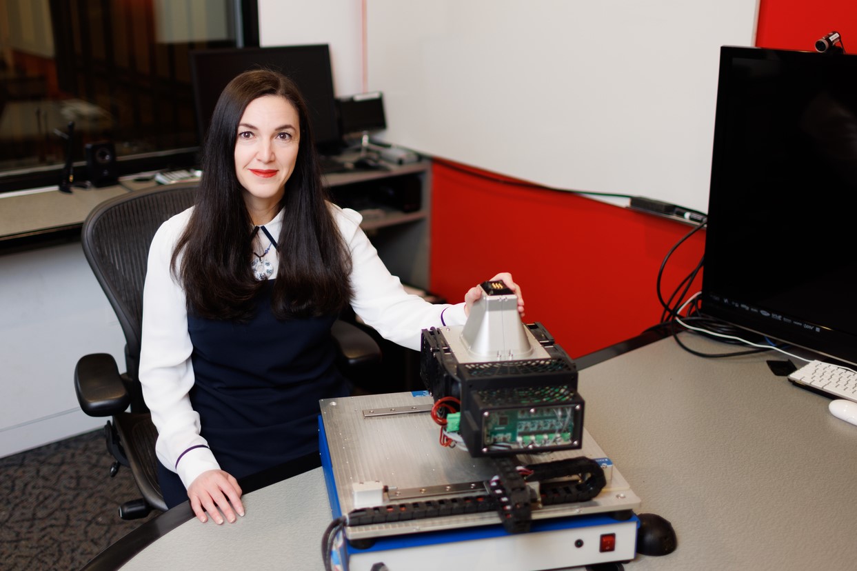 Professor Mounia Ziat sits at table, upon which is the machine she will use to test edge perception.