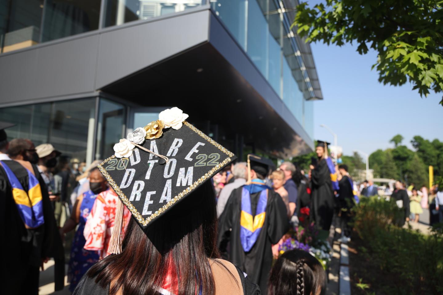 A graduate cap reads "Dare to Dream"
